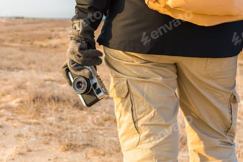 Preview: Selective focus closeup of a male's hand holding a vintage camera