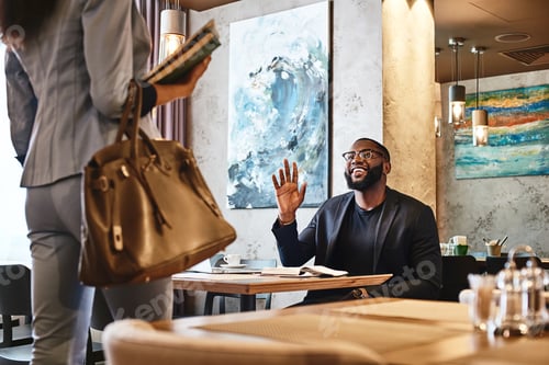 Preview: Excited businessman waving to his female colleague. Business communication concept