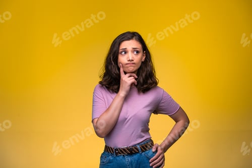 Preview: Young girl putting her finger to her cheek and trying to remember