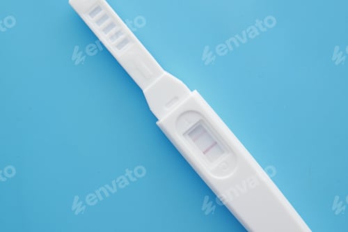 Preview: Pregnancy test kit on blue background