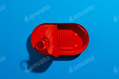 Preview: Red tin can on blue background close up