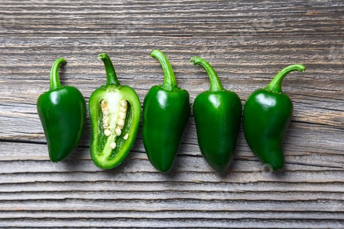 Preview: Green mexican jalapeno hot peppers placed in a row
