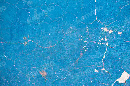 Preview: Weathered and aged blue wall with a variety of cracks and crevices, perfect for a background