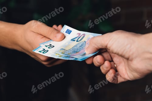 Preview: Hand of woman is giving euro money to a young man hand.