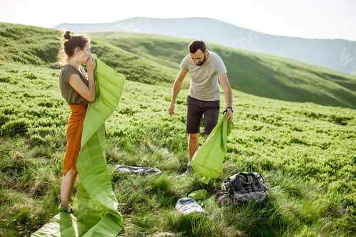 Preview: Couple setting up the tent in the mountains