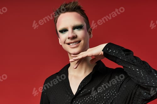 Preview: Stylish Young Drag Artist Posing Dramatically Against a Bold Red Background