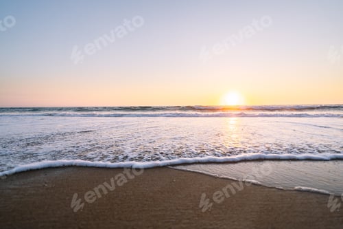 Preview: Sunset Horizon Over Gentle Sea Waves at Sandy Beach