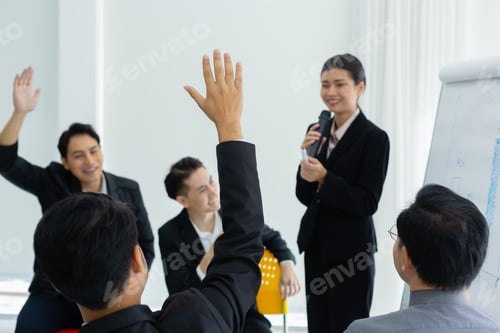 Preview: business person showing hand up for presentation in meeting room seminar training.