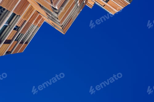 Preview: modern building clad in ecological wood over clean blue sky, concept of sustainable construction