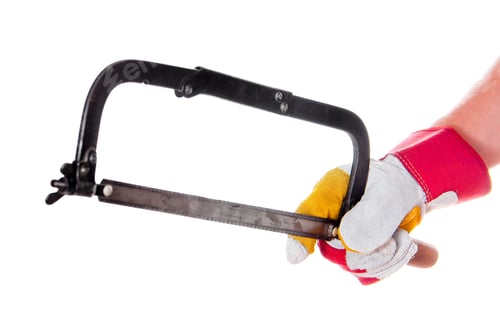 Preview: gloved hand with hacksaw