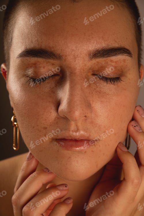 Preview: A swarthy girl with short hair and freckles with closed eyes. Authentic close-up portrait