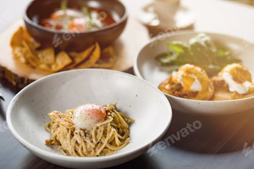 Preview: Lunch Time at Cafe. Pasta with poached egg on table isolated close-up