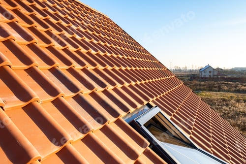 Preview: Overlapping rows of yellow ceramic roofing tiles covering residential building roof