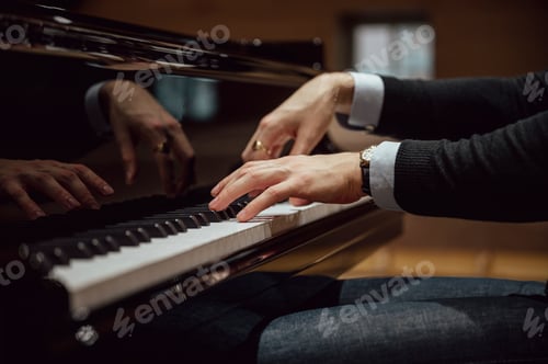 Preview: Low angle view of hands of a pianist playing pian