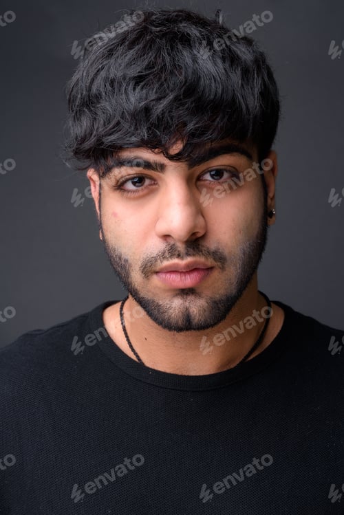 Preview: Young handsome Indian man against gray background
