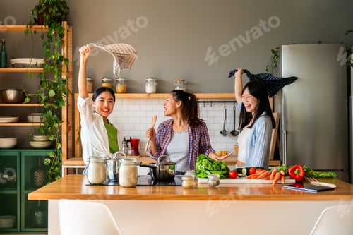 Preview: Happy beautiful chinese women friends bonding at home