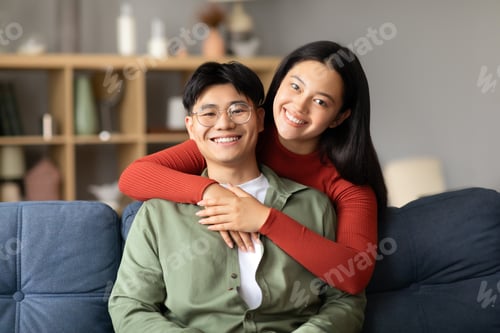 Preview: Loving Japanese Married Couple In Casual Embracing Posing At Home