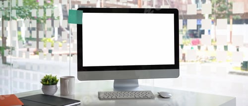Preview: Mock up computer with white screen, notebook, coffee cup and plant at modern office.