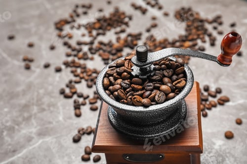 Preview: Coffee grinder with roasted beans on grey background