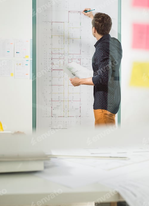 Preview: Young architect in office working at construction plan