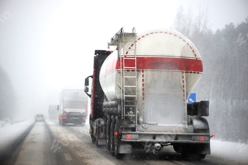 Preview: Blurred background of truck on highway in winter. Freight transportation, fuel transportation