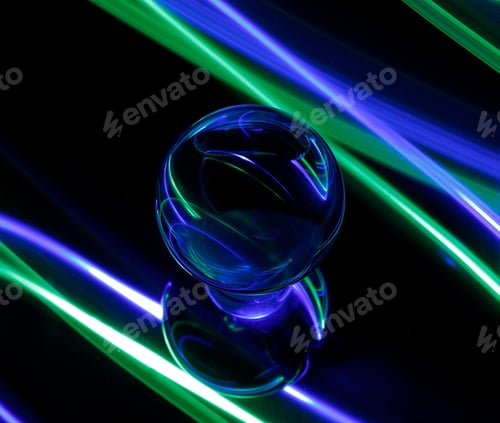 Preview: Intriguing green and blue light emanating from a light bulb in a dimly lit setting
