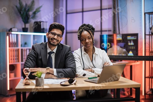 Preview: Two multi ethnic economists, experienced african american female and arab male office manager