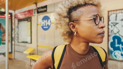 Preview: Close-up, woman in glasses, wearing brown top with backpack on her shoulders