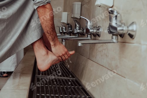 Preview: A Muslim performing ablution. Ritual religious cleansing of Muslims before performing prayer. The