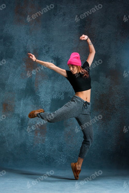 Preview: Young Girl Break Dancing On Wall Background.
