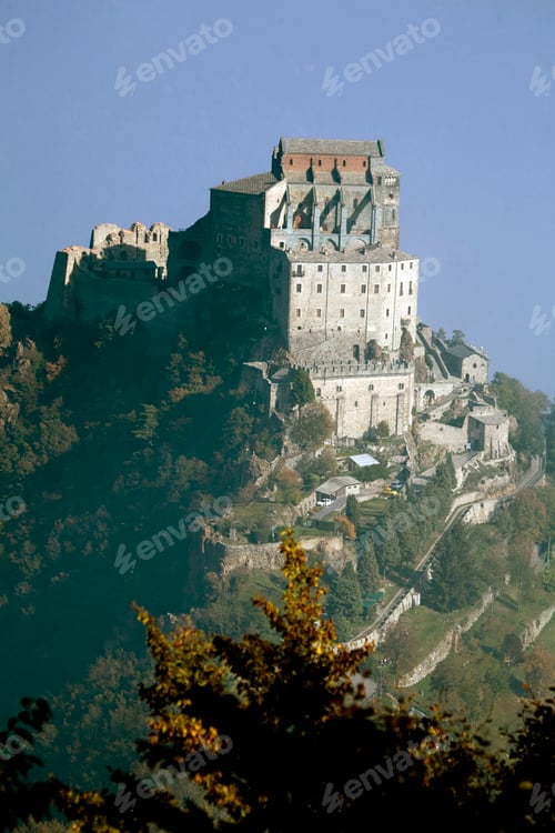 Preview: Majestic castle perched atop a misty hill with autumn foliage in the foreground