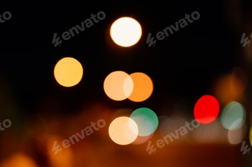 Preview: Bokeh traffic light at night in the street of a big city for background