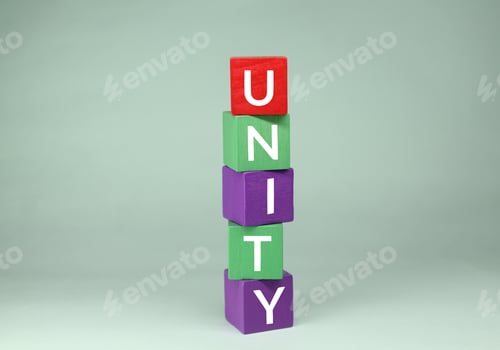 Preview: Time for a symbol of unity. standing wooden cube with the word unity