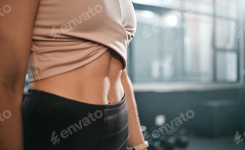 Preview: Fitness, stomach and woman in a gym for exercise, health or wellness for weightloss training. Sport