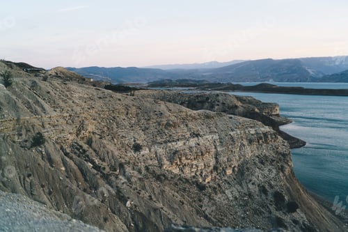Preview: Rocky mountain cliff near sea during daytime
