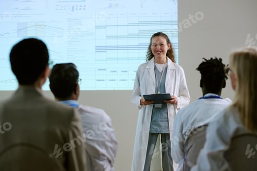 Preview: Young Adult Woman Presenting Medical Data to Diverse Colleagues