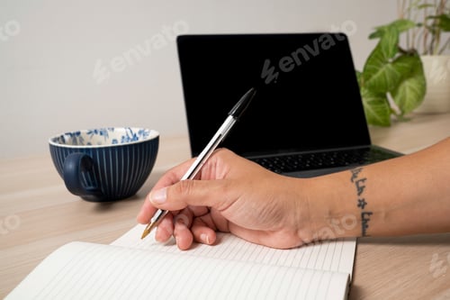 Preview: Close-up of hand of woman writing in notepad