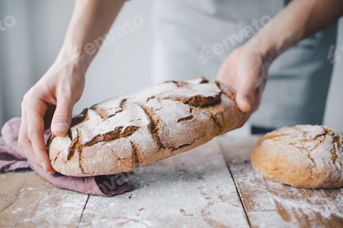 Preview: Baker or chef holding fresh made bread