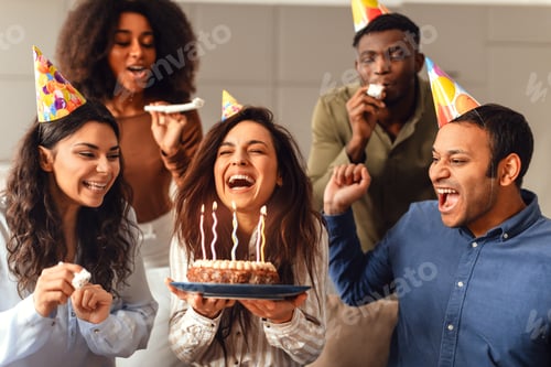 Preview: Diverse friends united in birthday celebration enjoying party together indoors
