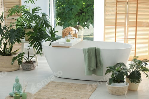 Preview: Stylish bathroom interior with modern tub and beautiful houseplants