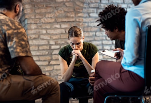 Preview: Group of diverse veterans talking during PTSD support group.