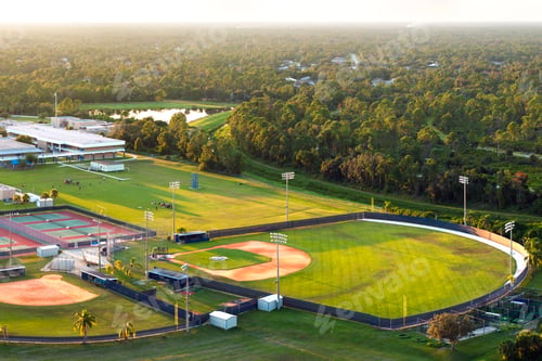 Preview: Sports facilities at public school in Florida, USA. American football stadium, tennis court