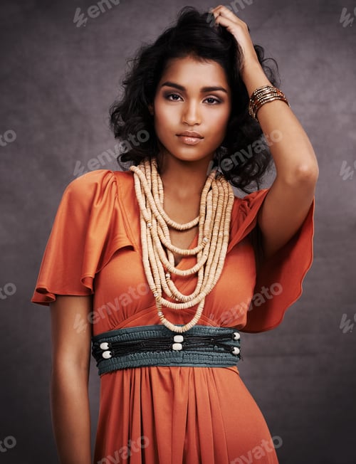 Preview: Studio portrait of a beautiful young fashion model posing against a gray background