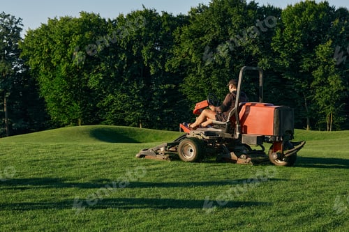 Preview: Greenkeeper. Golf course maintenance worker, cutting green grass