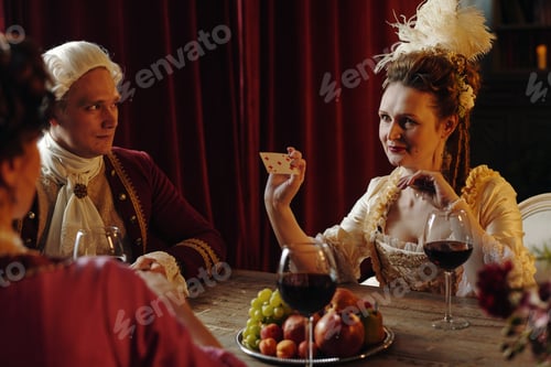 Preview: Caucasian Young Woman Showing Playing Card during Baroque Era Gathering