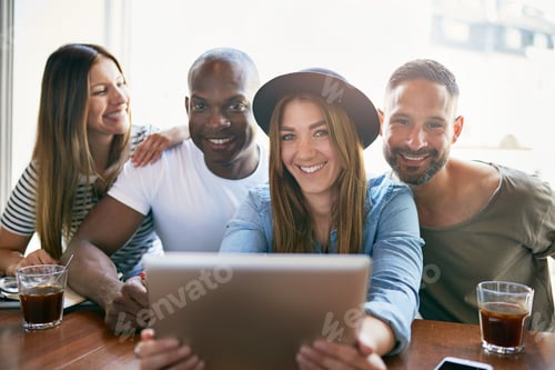 Preview: Group of smiling people sitting with tablet