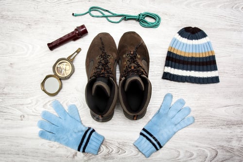 Preview: Winter hiking equipment lying on wooden floor, preparing for outdoor adventure