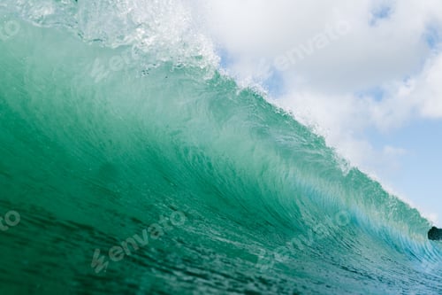 Preview: Beautiful shot of wave breaking in Carcavelos on a sunny day in Portugal