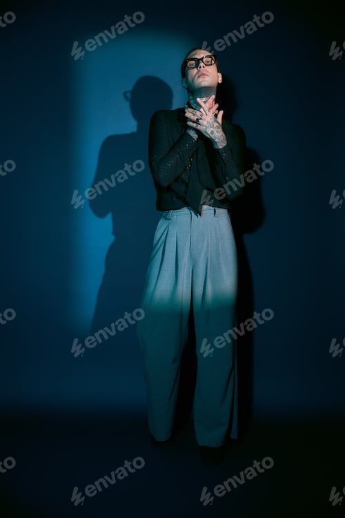 Preview: Handsome young man showcases unique style against a dark, artistic backdrop