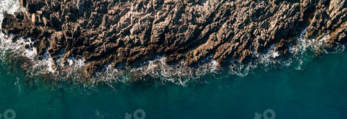 Preview: Wild ocean waters from above - waves hitting rocks - aerial photography.